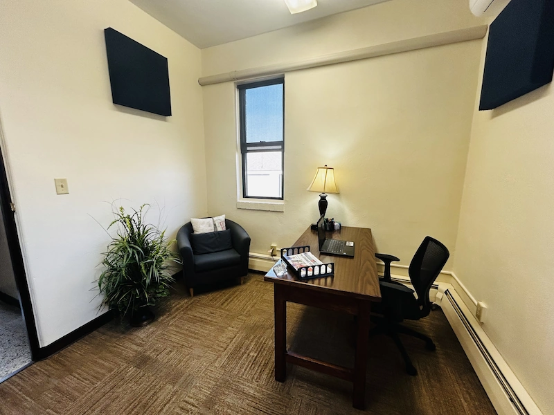 Small business office space at the Adrian Armory with single desk.