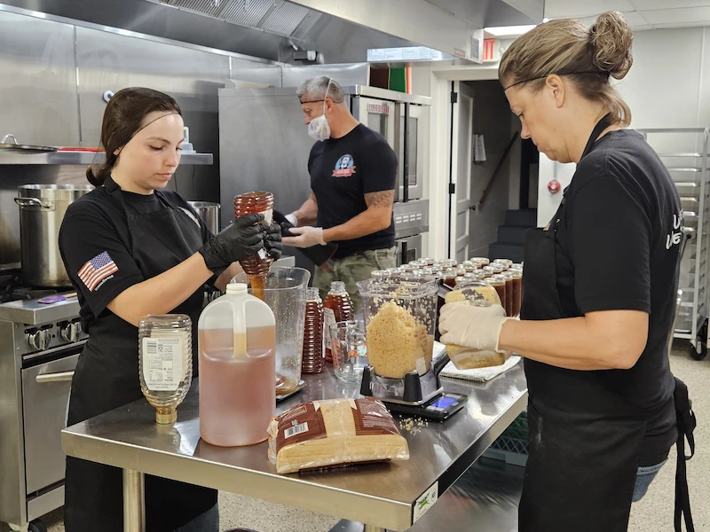 Food preparation in licensed commercial kitchen rental at Adrian Armory, Adrian Michigan.