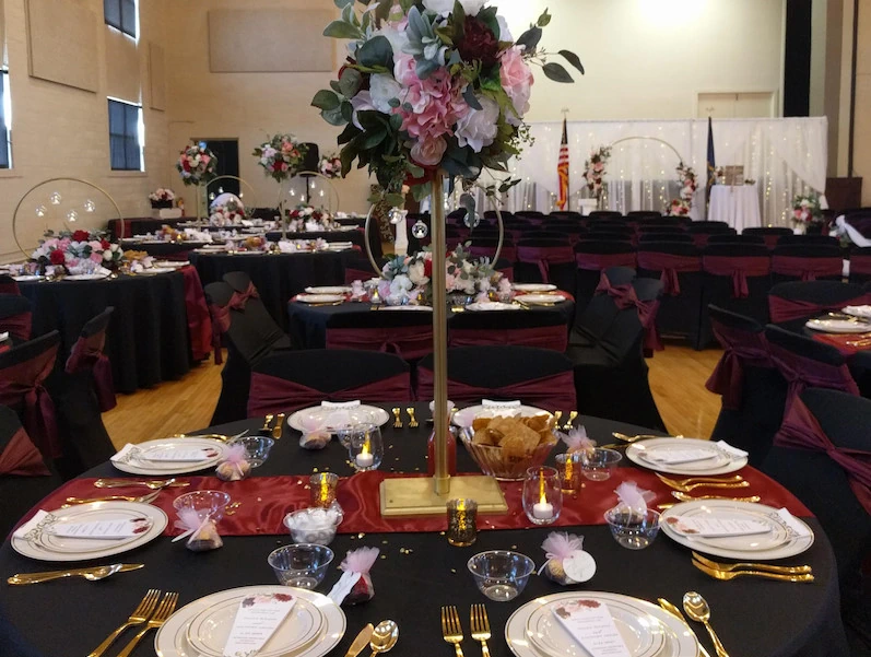 Decorated reception tables prepared for formal dinner at Adrian Armory wedding venue.